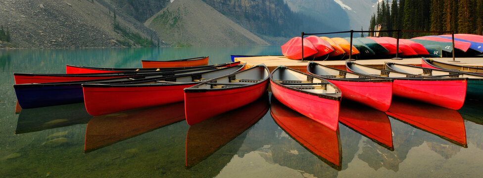 Red Canoes Docked at Moraine Lake in Banff National Forest in Alberta Canada