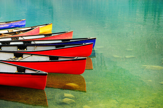 Red Canoes Docked at Moraine Lake in Banff National Forest in Alberta Canada