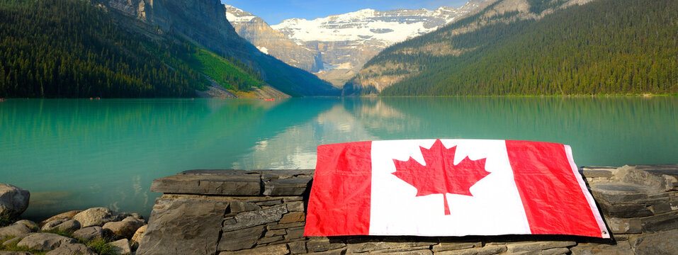 Canadian Flag Red Maple Leaf on Rocks at Lake Louise in Banff National Park in Alberta Canada