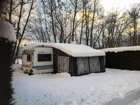 Ur, France; January 16 2017: Caravan with awning covered in winter snow in Ur, France