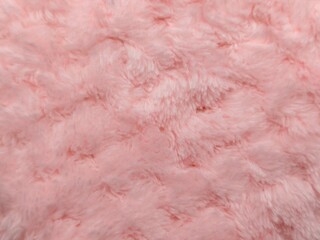 Macro view of soft pink plush fabric with a fluffy texture and velvety fibers, featuring cozy minky fleece material, subtle light highlights. © Antonios