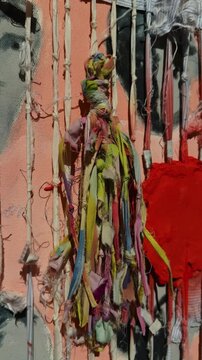 Textured abstract mixed media art canvas with colorful fabric threads ropes and knots close up view handmade craft background