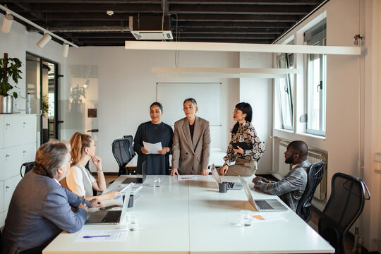 Business team presenting strategy in modern conference room
