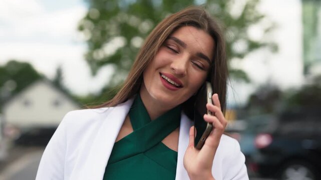 Close up portrait of beautiful young business woman talking on mobile phone, slow motion