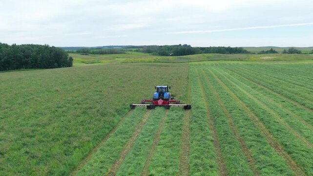 Drone Footage of Farm Tractor Mowing Grass for Hay Production