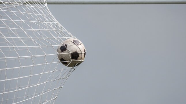 Soccer Ball Hitting the Back of Net Goal Concept with Copy Space
