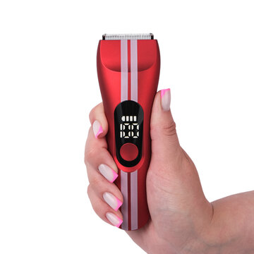 Close-up product shot of a high-end red waterproof electric shaver covered with water droplets, held gently in a male hand over a clean white background.