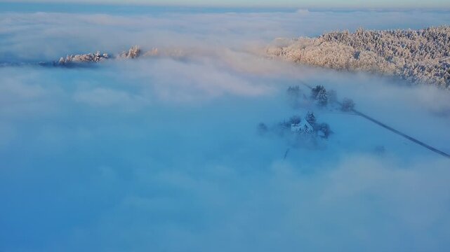 Majestic Aerial View of Foggy Winter Landscape at Golden Hour