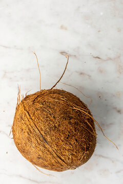 Closeup of coconuts on a white marble surface 