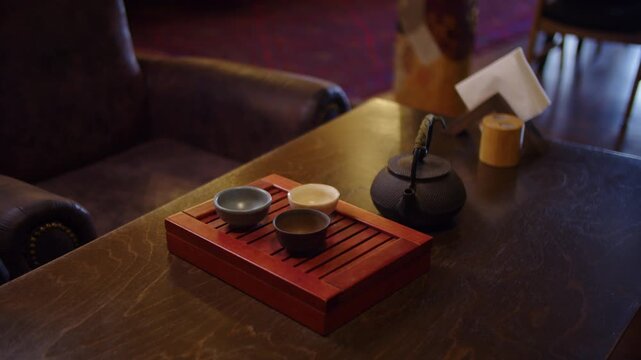 Tea set on cafe table with cozy interior