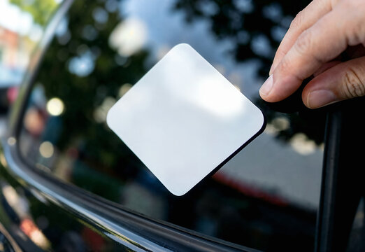 Blank rhombus vinyl sticker applied to car window, ai generated. Mockup for branding, decal design and vehicle graphics. Hand placing rhomb-shaped label for business logo or parking permits.