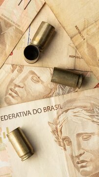 Used old ammunition casings with brazilian real bills