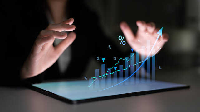 A professional setting with hands over a digital tablet, showcasing animated financial graphs and trends. Ideal for themes of analytics, growth, and business success. Cyphers