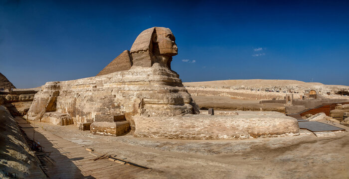 View of the Great Sphinx of Giza standing on the Giza plateau under a clear blue sky in Al Haram, Giza Governorate, Egypt.