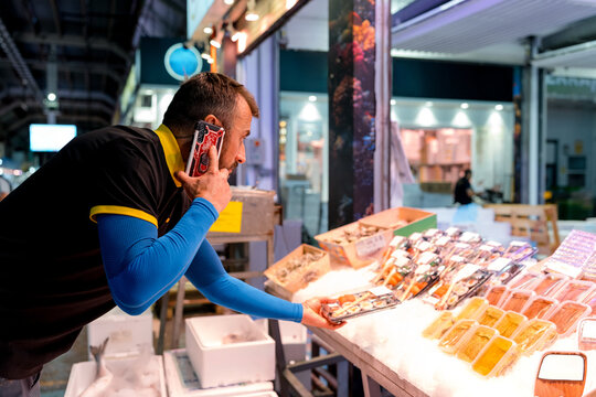 Fishmonger select fresh seafood at wholesale market