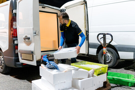 Fishmonger unload fish delivery from refrigerated van