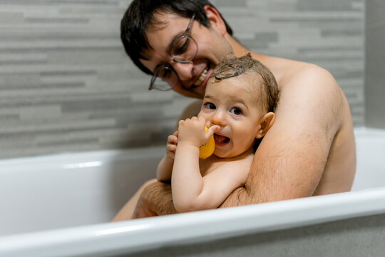Father and baby enjoying bath time together