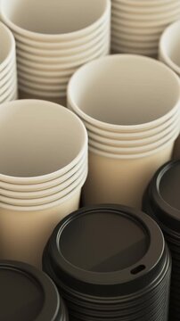 Camera pan over a stack of cups and lids in black for cafe packaging and takeaway beverage concept. Vertical video.