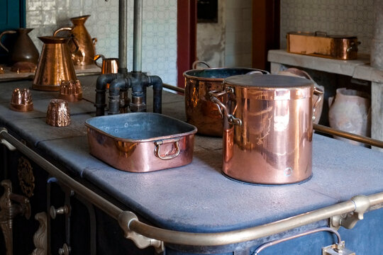Copper pots and pans on a kitchen counter