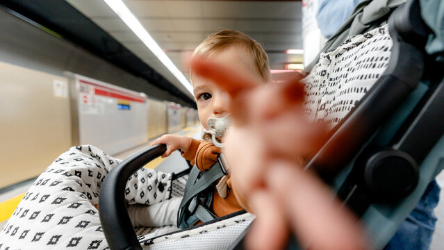 Baby in stroller waiting for subway in Tokyo