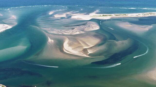 Currents from the Atlantic Ocean continuously shape the sand bars and scenic beaches of Cape Cod, Massachusetts. The entire peninsula is in constant movement due to its geologic makeup of mostly sand.