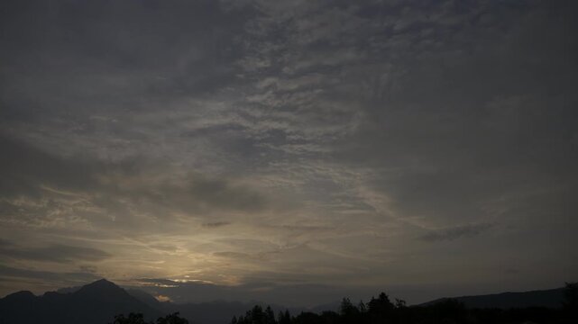 Morning sky time lapse video with sun rising and clouds changing shape, morning sky over the mountain landscape video background with copy space