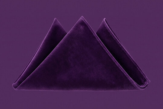 Purple velvet pocket square folded in a three point crown on a matching background