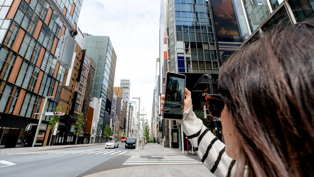 Woman capturing Chuo-dori in Tokyo's Ginza district