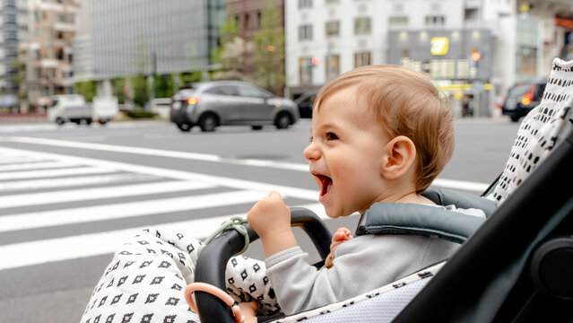 Happy baby in stroller in Ginza, Tokyo street scene