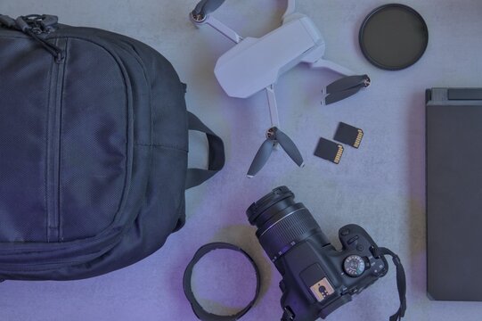Audiovisual workspace with laptop, drone camera, filters, and memory cards. Content creation	