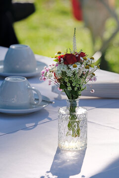 Outdoor event with flowers and coffee cups on the table