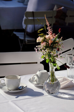 Outdoor event with flowers and coffee cups on the table