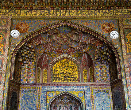 View of the intricate tile work, vibrant calligraphy, and ornate muqarnas inside the historic Wazir Khan Mosque in Lahore, Punjab, Pakistan.