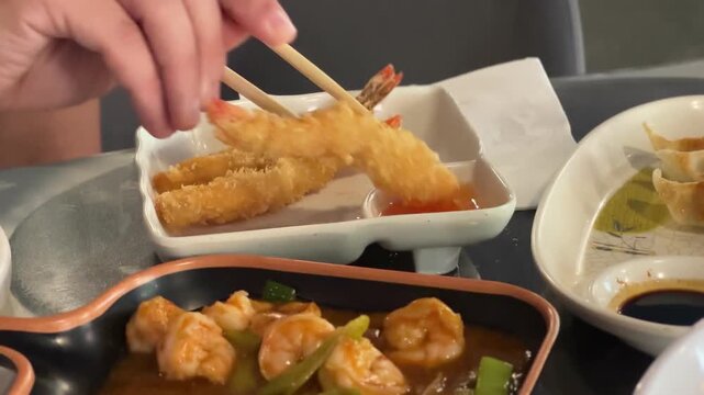 Tempura shrimp with sweet chili sauce beside a shrimp dish