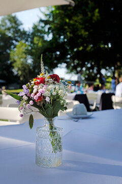 Outdoor event with flowers and coffee cups on the table