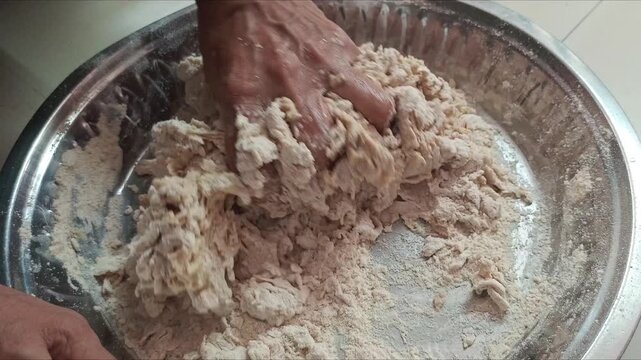 Close-up of woman hands sifting wheat flour and kneading dough in traditional dish