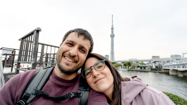 Couple selfie with Tokyo Skytree beside Sumida River