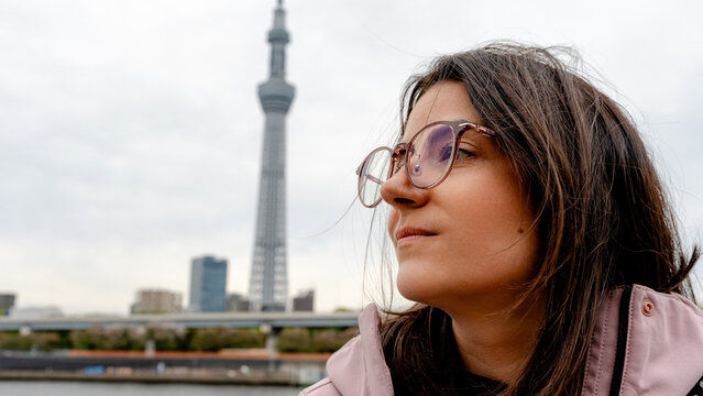 Woman near Tokyo Skytree beside Sumida River in Japan