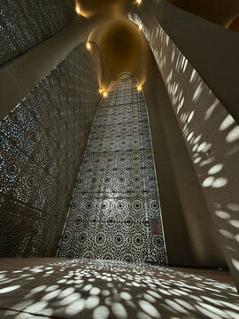 View of the intricate geometric mashrabiya screens and dramatic light patterns inside the Abrahamic Family House in Abu Dhabi, Abu Dhabi, United Arab Emirates.