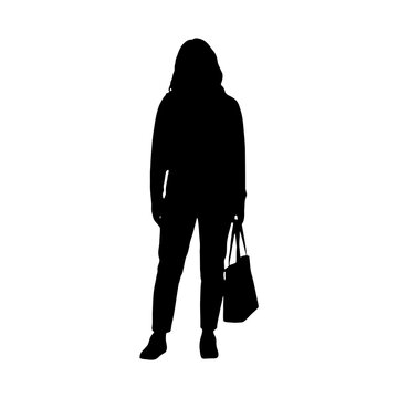 Silhouette of woman walking with handbag