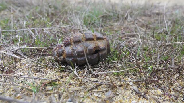 The protracted war concept. A partially exploded hand onion grenade on the battlefield