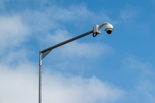 View of a security camera mounted on a metal pole against a blue sky in Porto, Porto District, Portugal.