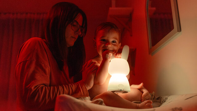 Mother and baby at home with glowing bunny night light