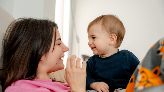 Mother and baby smiling together in cozy home moment