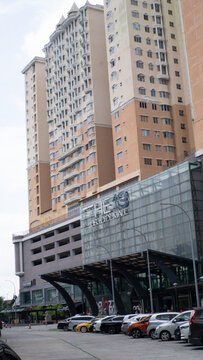 Exterior view of The 19 USJ City Mall entrance building with parked cars and glass facade in Subang Jaya, Malaysia.