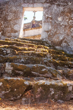 Horizontal view of the old mossy stone steps leading up to the historic Sao Cristovao chapel portal in Freixo, Ponte de Lima, North Portugal.
