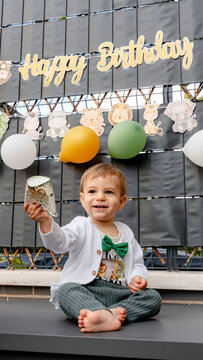 Baby first birthday celebration with balloons and happy sign
