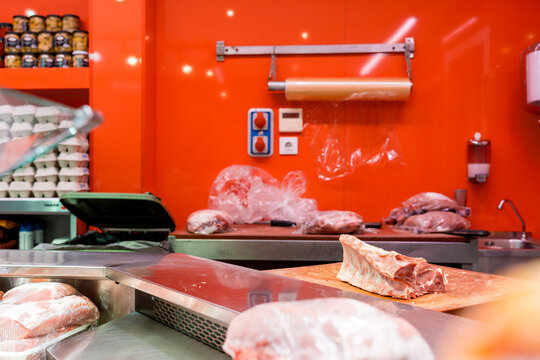 Butcher shop counter with raw meat cuts on cutting board
