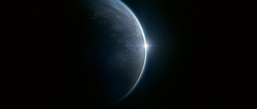 Sunrise over planet Earth viewed from space. Bright sunburst on dark planetary horizon with atmospheric glow, black space background