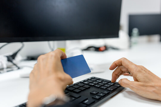 Online payment with credit card on office computer keyboard
